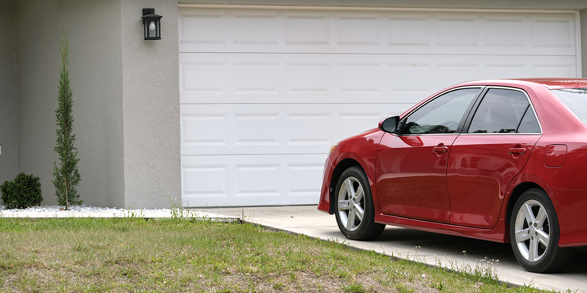 An image showing a car parked in a driveway for a long period