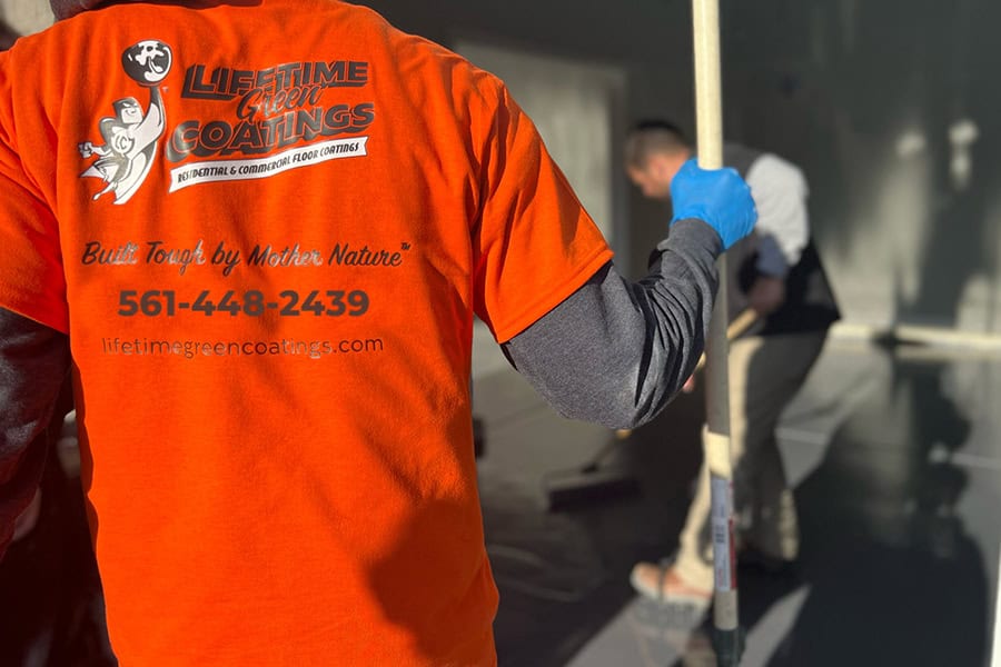 Lifetime-Green-Coatings-floor-experts-are-applying-new-driveway-floor-coating-on-a-concrete-surface-to-prevent-random-cracking Lifetime Green Coatings floor experts are applying new driveway floor coating on a concrete surface to prevent random cracking 1