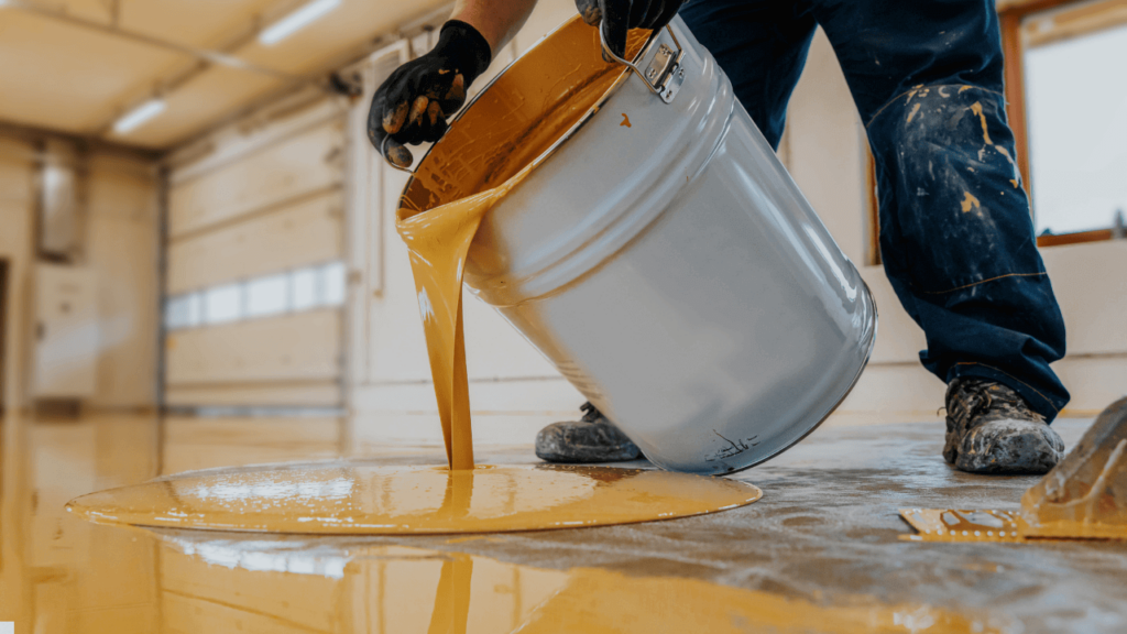 Technician applying a non-toxic, plant-based floor coating in a garage Technician applying a non-toxic, plant-based floor coating in a garage