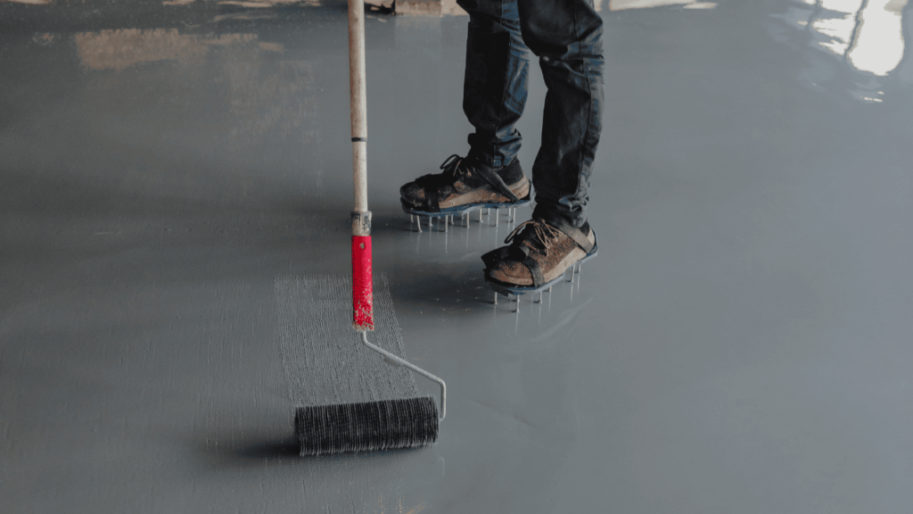 Technician applying durable, plant-based floor coating in a workshop image Technician applying durable, plant-based floor coating in a workshop